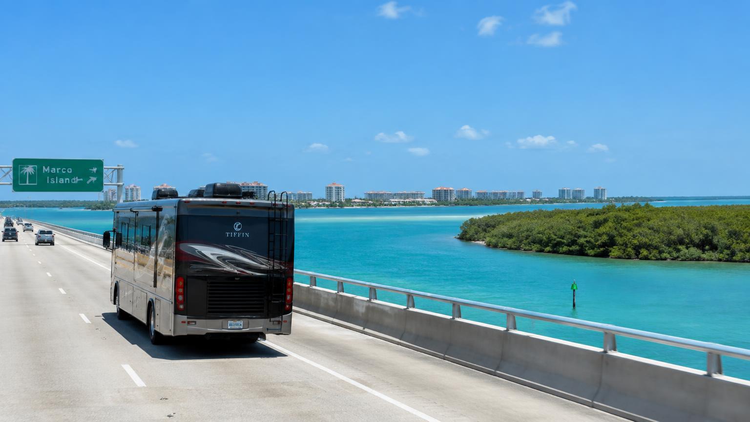 Class A motorhome crossing the bridge toward Marco Island, Florida over turquoise water